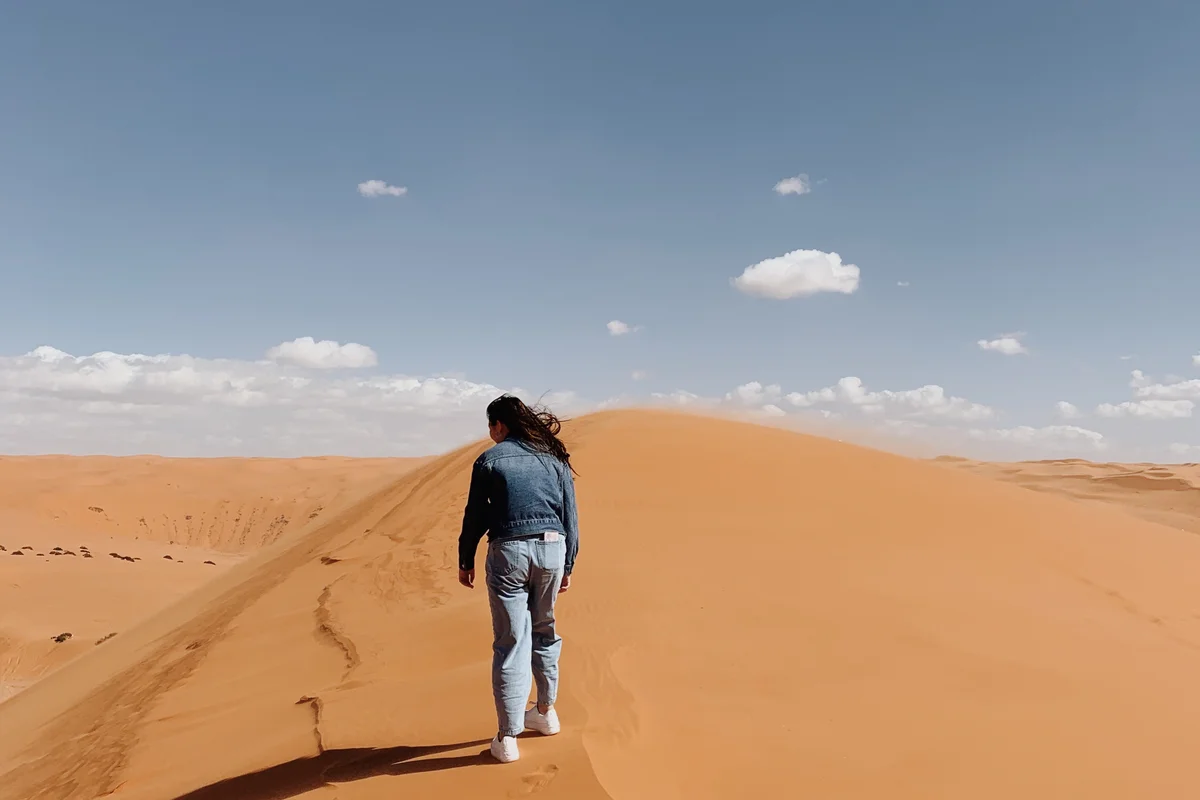 Expansive desert dunes and rugged terrain characteristic of the Madinah region in western Saudi Arabia