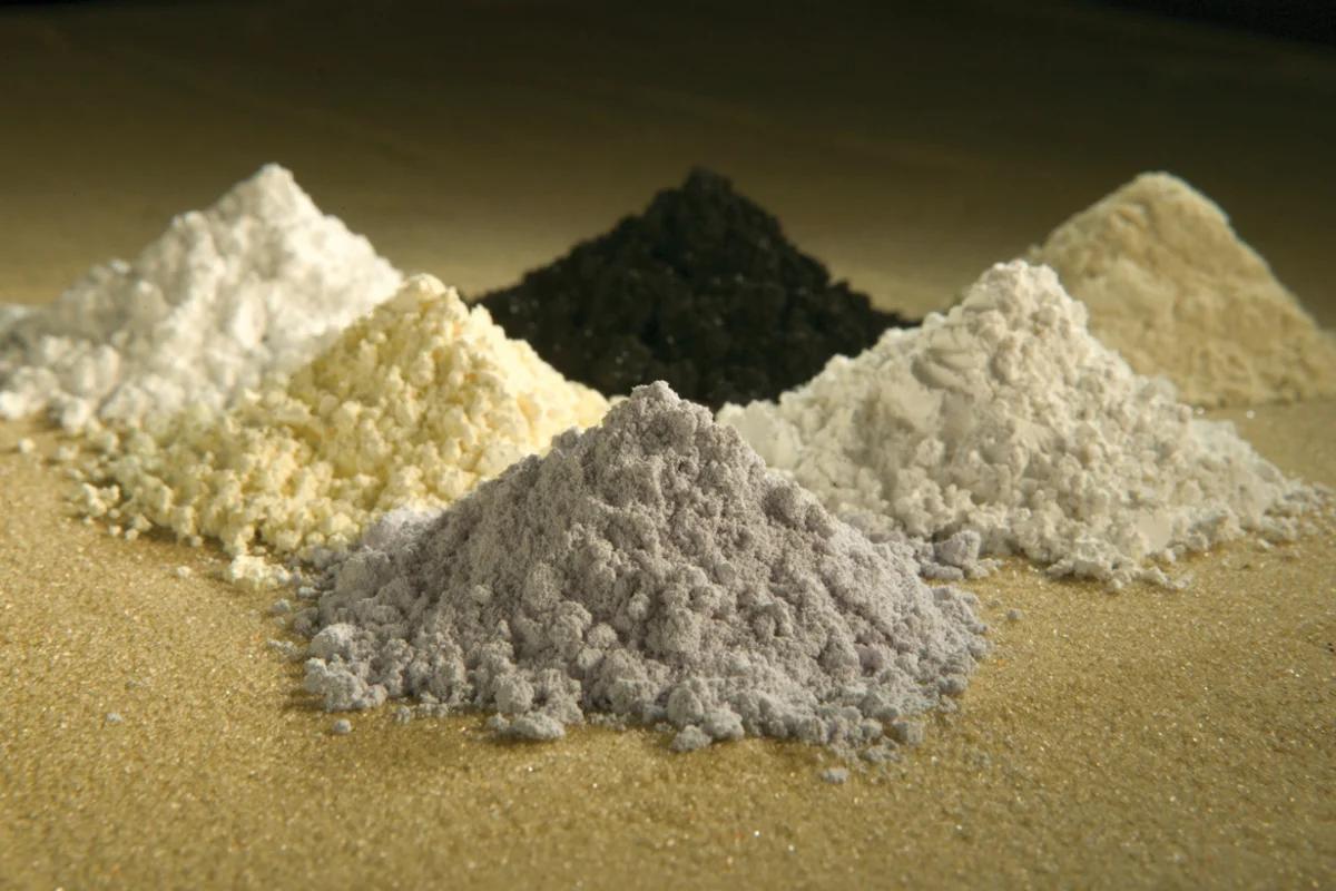 Purified rare-earth oxide powders in laboratory Petri dishes representing the critical elements discovered at Jabal Sayid